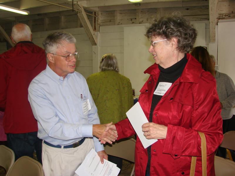Larry Hayter, left, of the Old Bristol Historical Society, meets Harriet Vaughan of the Whitefield Historical Society, in the Nickels-Sortwell Barn in Wiscasset on September 22. SUSAN JOHNS/Wiscasset Newspaper