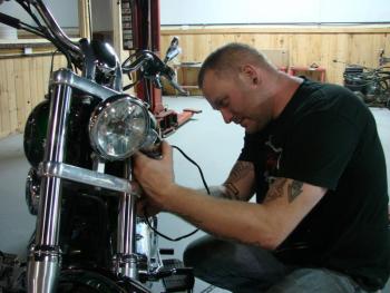 Darron Pierce changes a part on a customer's bike at the new Route 1 business, Twisted Iron Customs. SUSAN JOHNS/Wiscasset Newspaper
